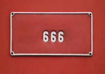 Rounded white numbers 666 on red background.  Number 666 on red wall background. new painting wall.