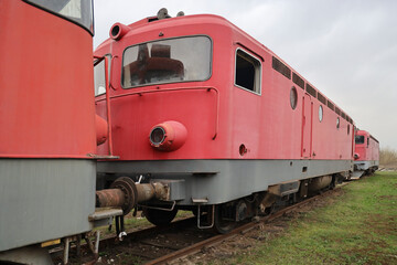 buffers of coupled historic railroad cars old retro vintage aged red locomotive wagons.