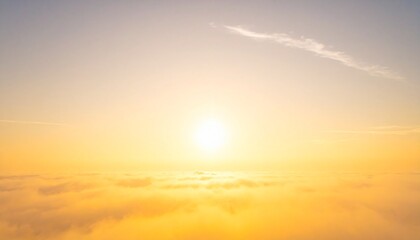 Obraz premium Golden sunlight streams over a peaceful ocean of clouds, creating a heavenly and serene aerial morning or evening view from above the sky