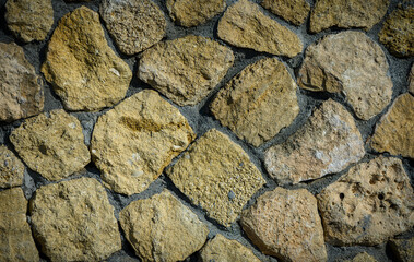Stone Facade with Sunbeams and Rustic Texture Background