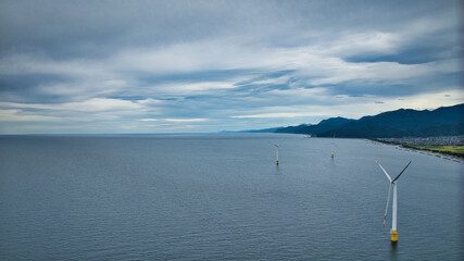 雨が降りそうな9月の富山県入善町沿岸からみる洋上風力発電風車をはじめとする様々なもの