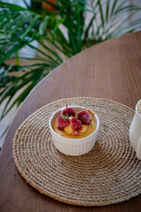 Cottage cheese souffle with orange curd decorated with frozen berries. Side view, close-up. delicious, cottage cheese, fruit cream, strawberry, red currant