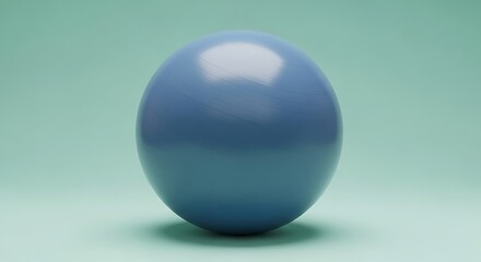 Fitness ball for yoga and pilates training on a light blue surface