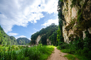 Mountain cliffside dirt path in Lanno Valley, a park surrounded by karst limestone mountain in...