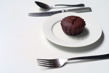 Lava chocolate cake on a plate with utensils 