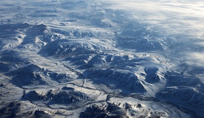 High-altitude view of snow-capped mountains and valleys