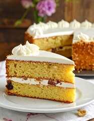 A delectable slice of layered cake, adorned with a generous layer of creamy white frosting, showcasing a golden-yellow interior.