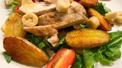 Grilled chicken nestles on a vibrant bed of arugula with golden potatoes, perfect for Solstice feasting or Harvest Home