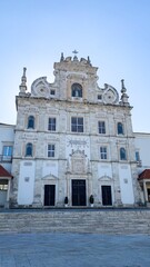 Baroque splendor of sunlit Rococo facade whispers tales of ancient festivals, Iberian devotion peaks in marbled serenity
