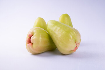 Fresh tropical water guava fruits with light green and pink skin isolated on white background, organic produce rich in vitamins, perfect for healthy diet and natural food concept