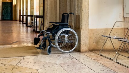 Silent wheelchair in historic hallway whispers stories of resilience, echoing Disability Pride and International Day of Acceptance