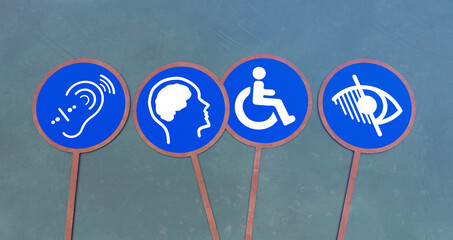 Accessible Symbols: A close-up shot featuring four universally recognized accessibility signs, visually representing inclusivity and equal opportunity for individuals with disabilities.