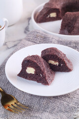 black sticky rice cake filled with cheese it called bolu ketan hitam keju lumer. Indonesian food. 
