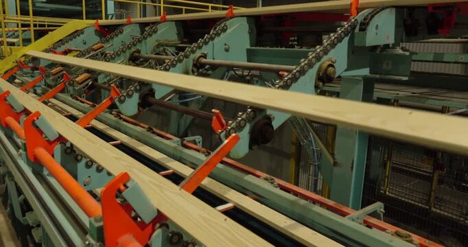 A woodworking plant. The boards are moved along a conveyor belt at a woodworking plant. The woodworking industry.