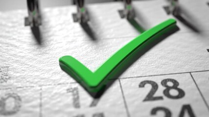 Close-up of a textured calendar with a vibrant green checkmark on the 28th, signifying a marked date or completed task