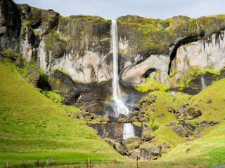 Foss a Sidu waterfall in Southern Iceland with sunshine and rainbow