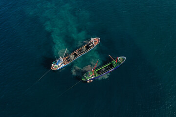 Image of ships removing sand from the sea.
