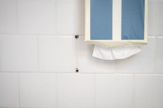 Soft focus tissues paper towel dispenser on granite wall in barthroom