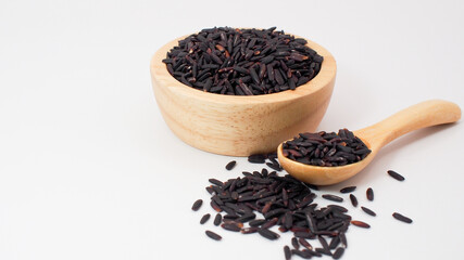 Riceberry rice grains in a wooden bowl and spoon with scattered seeds on a clean white background, representing healthy food and organic nutrition.