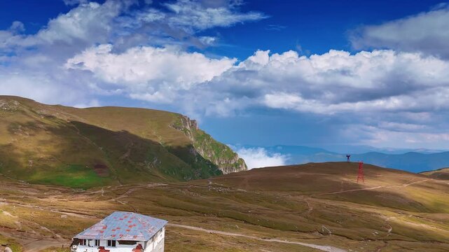 Exploring the natural beauty of busteni in romania. Travelers enjoy breathtaking views of Busteni's mountains and valleys under a dramatic sky filled with clouds.