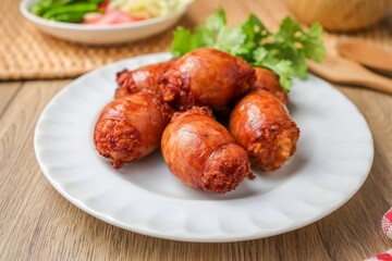 Fried Isaan sausages in a white plate ,Thai called sai krok isan