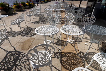 White Ornate Cast Iron Patio Bistro Set with Decorative Shadows