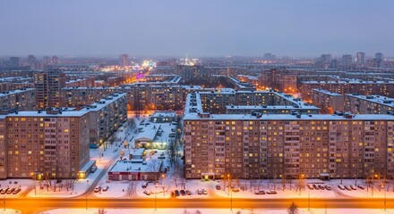 Cityscape aerial view winter scene residential buildings snow covered rooftops urban landscape cold evening