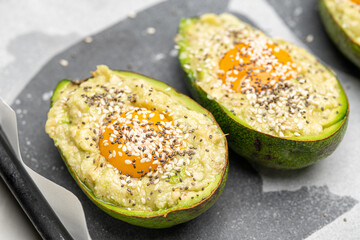 Fresh Avocado Half Filled with Egg and Sesame Seeds for Oven Cooking