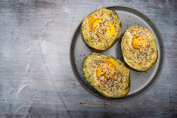 Flat Lay of Oven Baked Avocado with Egg and Seeds for Healthy Eating Concept