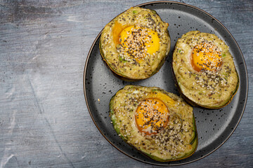 Avocado Half Filled with Egg and Sprinkled with Seeds, Copy Space Background