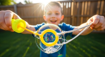 Happy Young Boy Playing with Soap Bubbles Outside in Backyard During Sunny Day