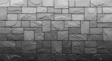 A textured wall composed of various gray rectangular and square stone tiles, displaying a subtle gradient from light to dark.