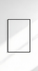 Minimalist Empty Black Frame on a Clean White Wall with Sun Shadows