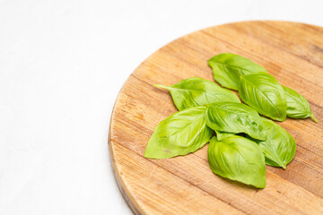 Close Up of Basil Leaves on Rustic Wooden Chopping Board