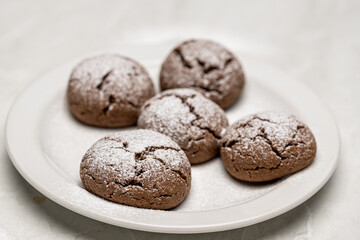 Close Up of Chocolate Cookies Sprinkled with Sugar Powder on Serving Plate