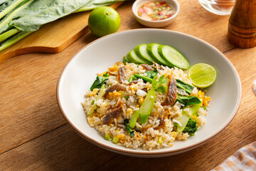 Fried rice with salted fish,Salted Fish and Chinese Broccoli Fried Rice in white plate.