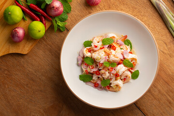 Spicy Lemongrass Salad with Shrimps in white plate.Thai food.Top view.