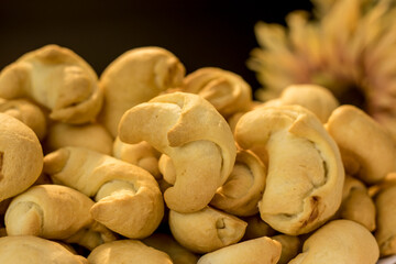 Small croissants made from yeast dough, hand-rolled. Delicious homemade sweets. A large quantity of small baked croissants with fillings. Delicious autumn sweet desserts. Sweet homemade baked goods.