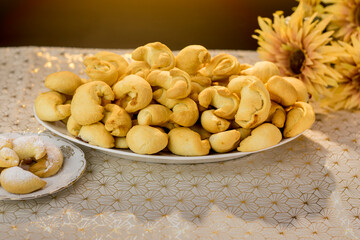 Delicious homemade croissants made from yeast dough with filling. A plateful of dessert pastries, on a large plate, on a white napkin and black background. Sweet diet. Homemade cookies and sweets.