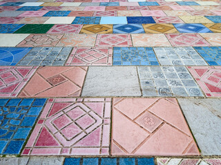 beautiful colorful mosaic floor made of broken ceramic tiles with abstract patterns. Ideal for texture background, recycled art, tile design, and creative surface concept.