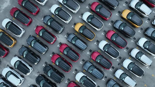 Aerial view car for sale stock lot row, Cars dealership inventory distribution automobile and automotive business, New cars parking for sale automobile automotive industry business.