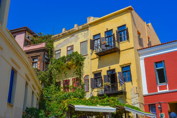 Greece, Chania, 07.09.2025: colorful traditional houses with bright facades in narrow mediterranean street