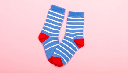 Obraz premium Pair of blue and white striped socks on pink background