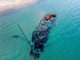 Aerial top down of wrecked boat Mediterranean Sea shipwreck beach Thessaloniki