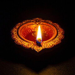 Traditional Diya Oil Lamp Glowing in the Dark for Spiritual and Festive Occasions