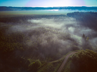 Aerial view landscape on foggy morning in countryside with lake and forest

