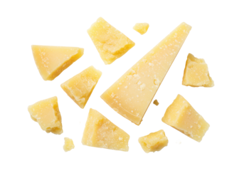 Authentic Parmesan cheese pieces, irregular golden-yellow, crumbly, artfully scattered on transparent studio background with copy space, gourmet culinary excellence