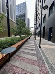 Tall buildings of a new residential complex, viewed from below from the courtyard, concrete jungles on a gray day.