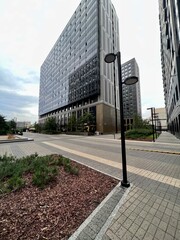 Tall buildings of a new residential complex, viewed from below from the courtyard, concrete jungles on a gray day.
