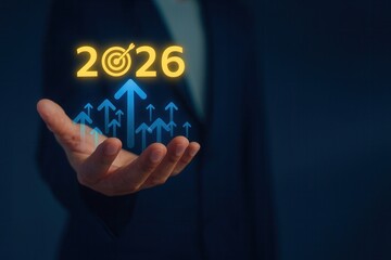 Businessman hand presenting rising arrows with 2026 text,concept of financial growth,goal achievement,success strategy,digital transformation and upward economic forecast